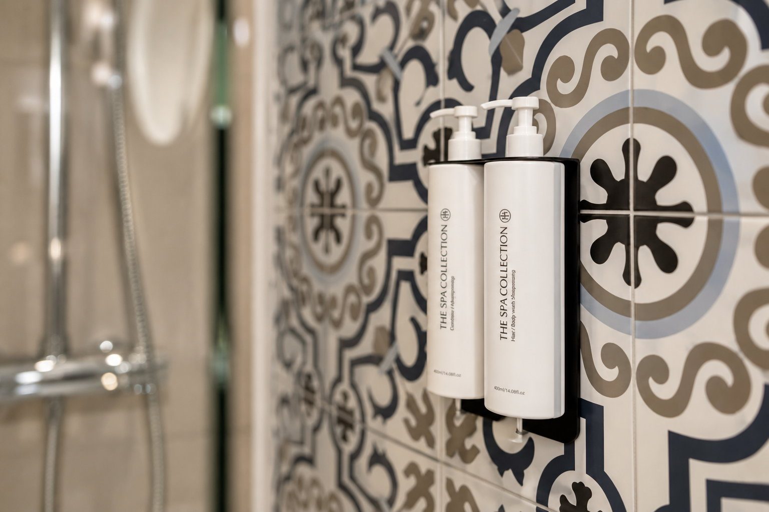 A guest bathroom at Majestic City Palace with blue and white majolica tile and a walk-in rain shower