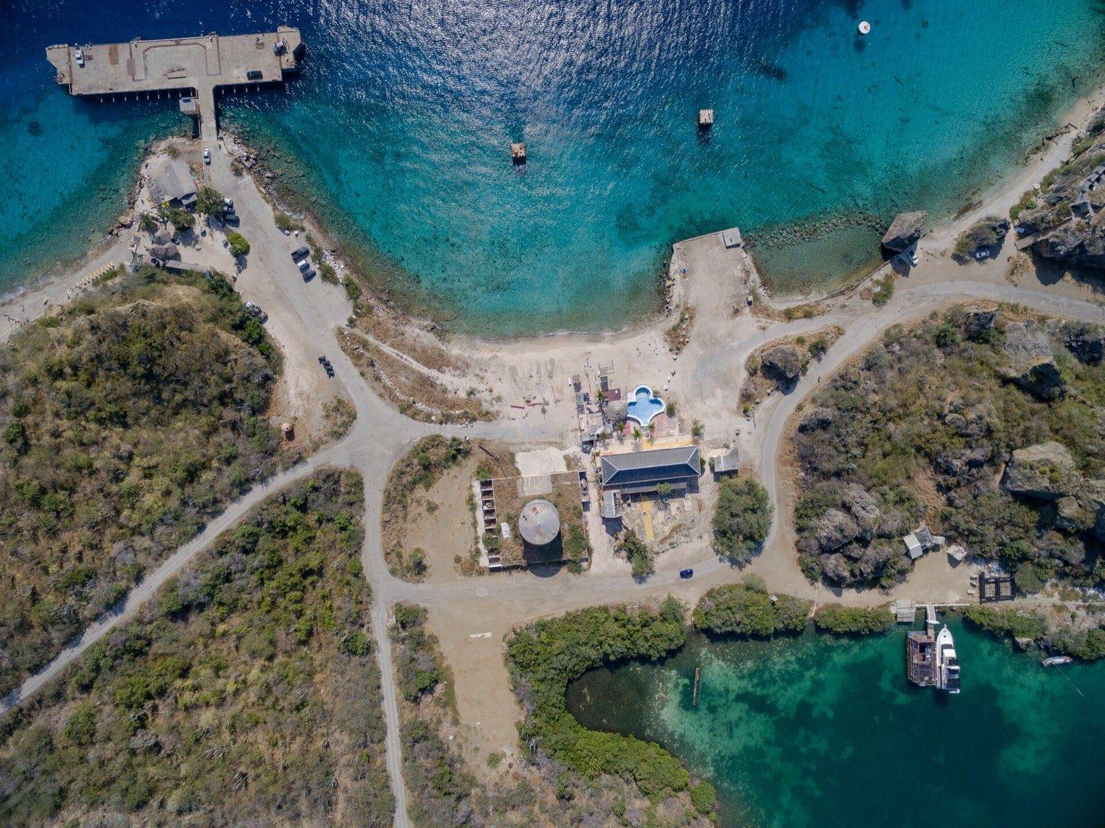Calm turquoise water and shaded loungers at Baya Beach on the southeast coast of Curaçao