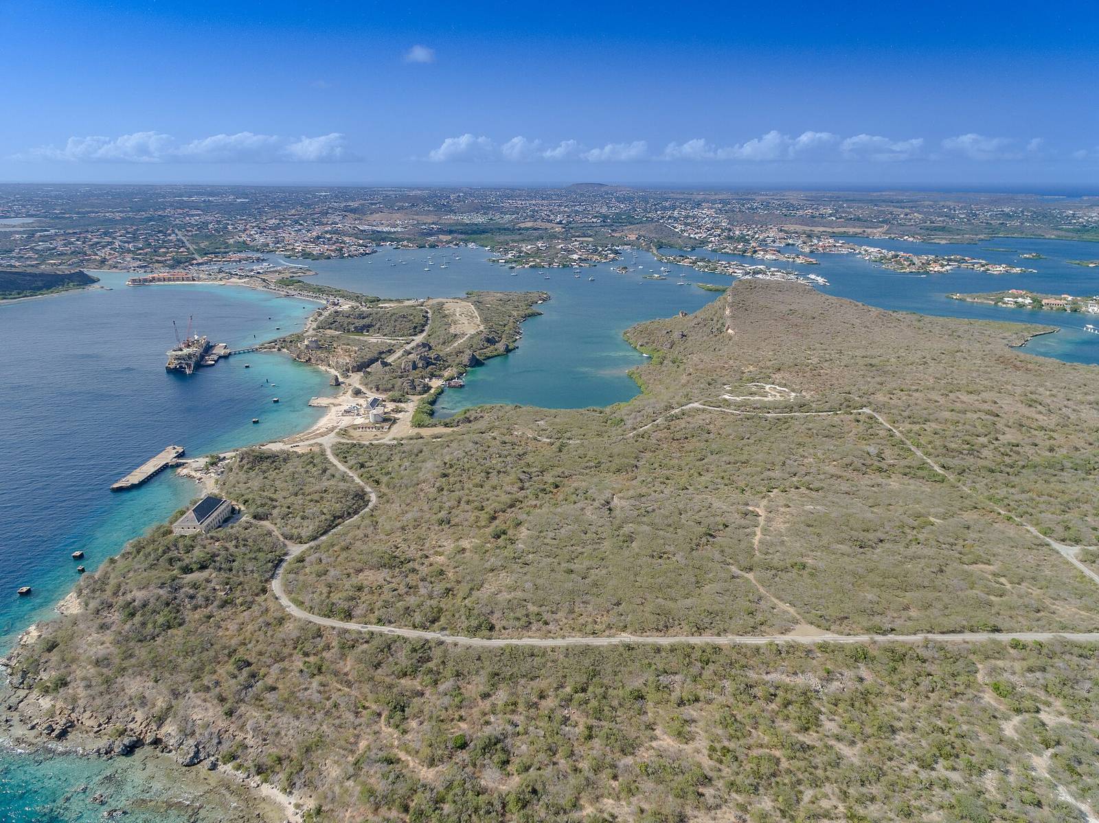 Aerial view of the Curaçao coastline with turquoise water and island roads