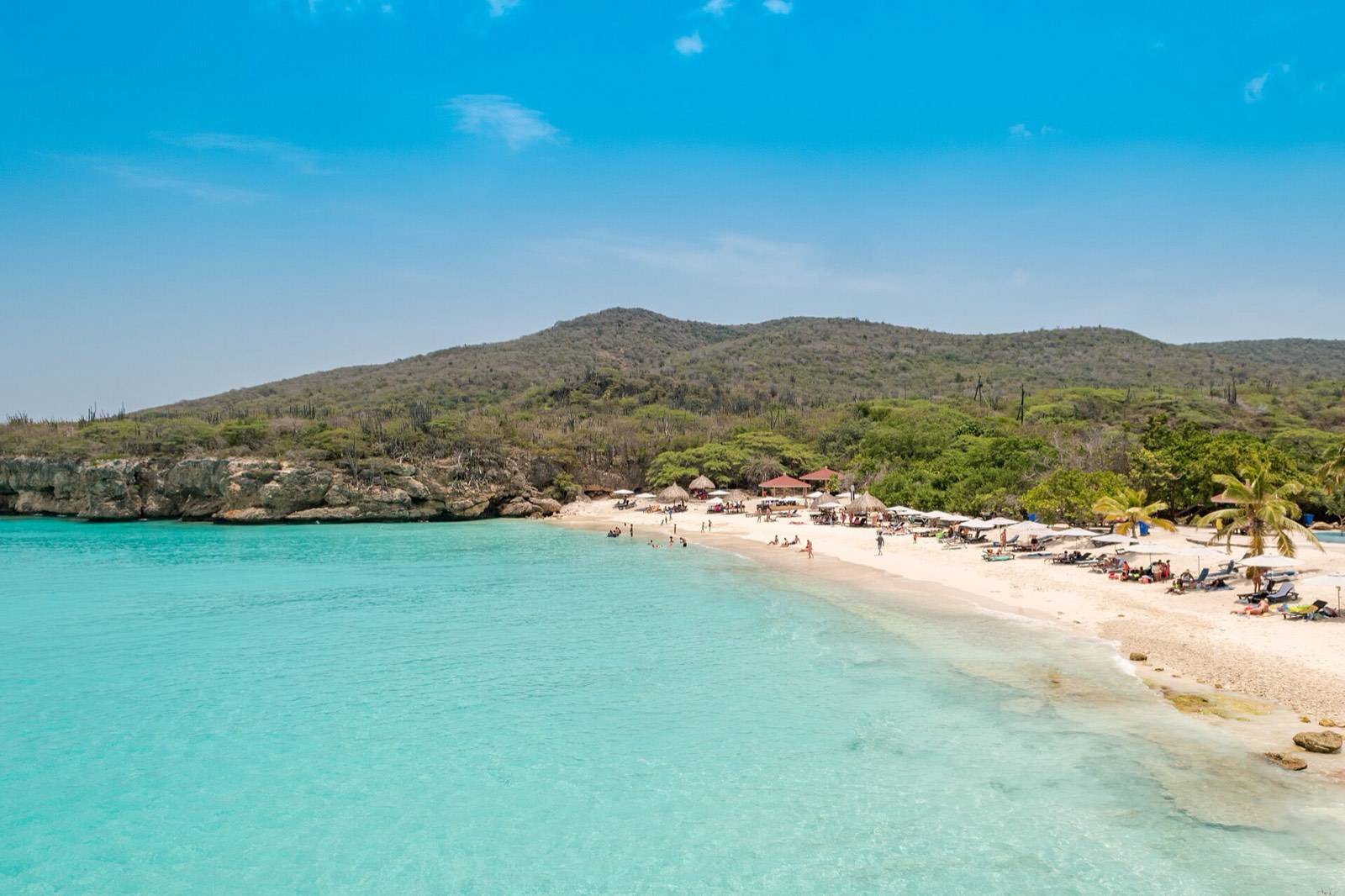 The white sand and turquoise bowl of Grote Knip beach seen from the cliff lookout on Curaçao's west end