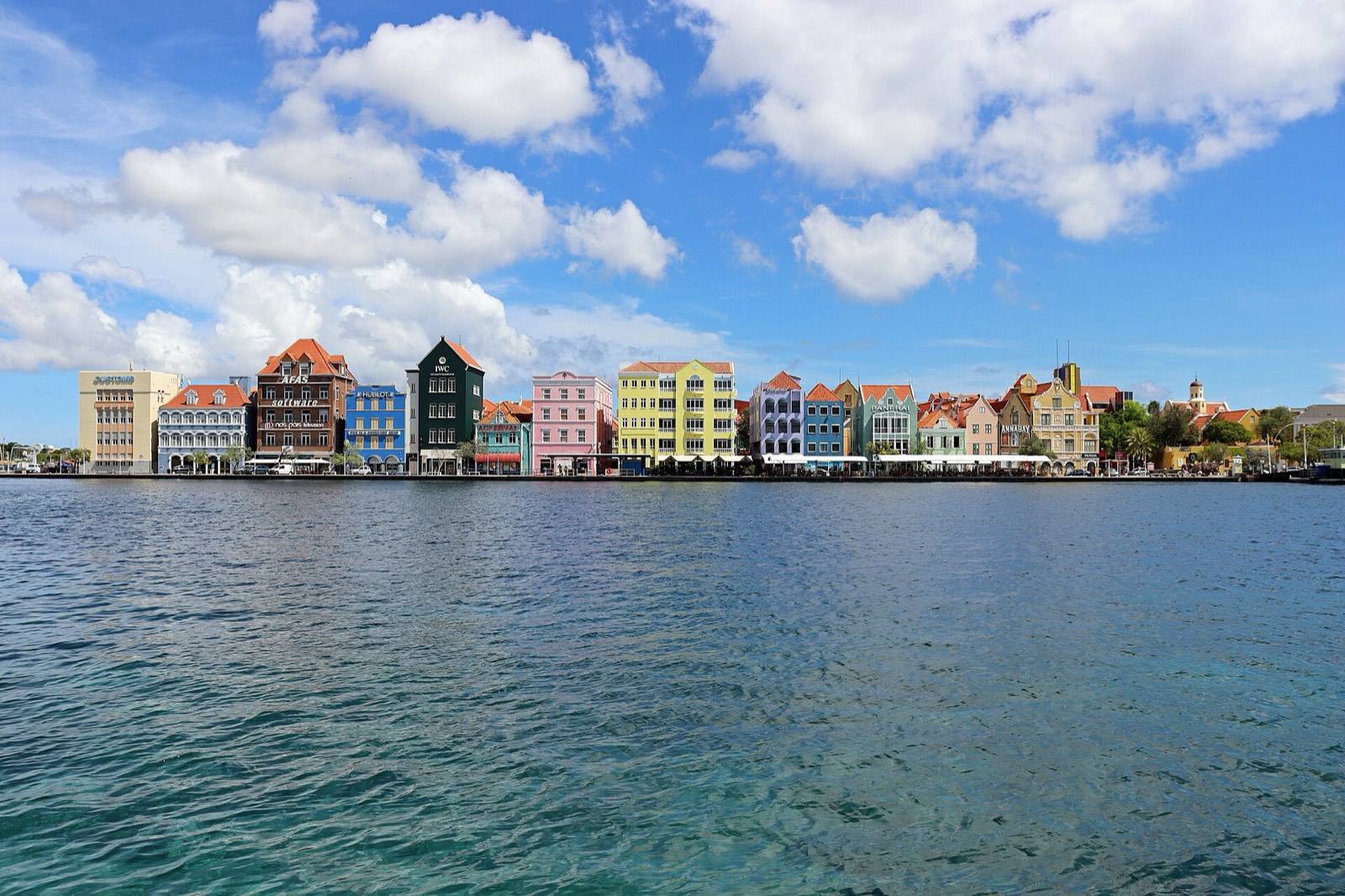 The colorful waterfront facades of the Handelskade in Willemstad, the first view that rewards travelers who arrive with their paperwork done