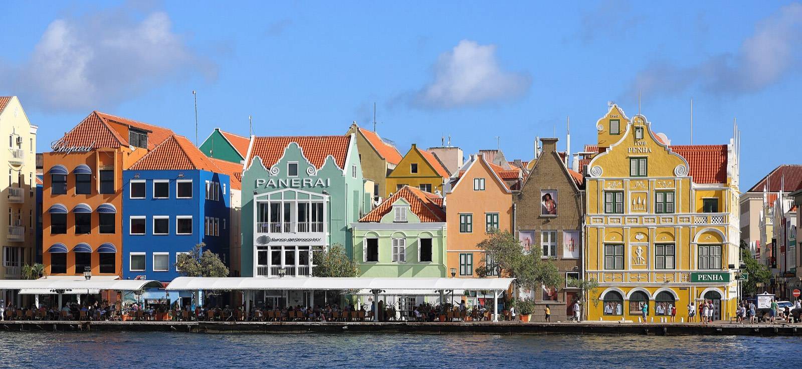 The famous row of pastel merchant facades along the Handelskade waterfront in Willemstad, Curaçao