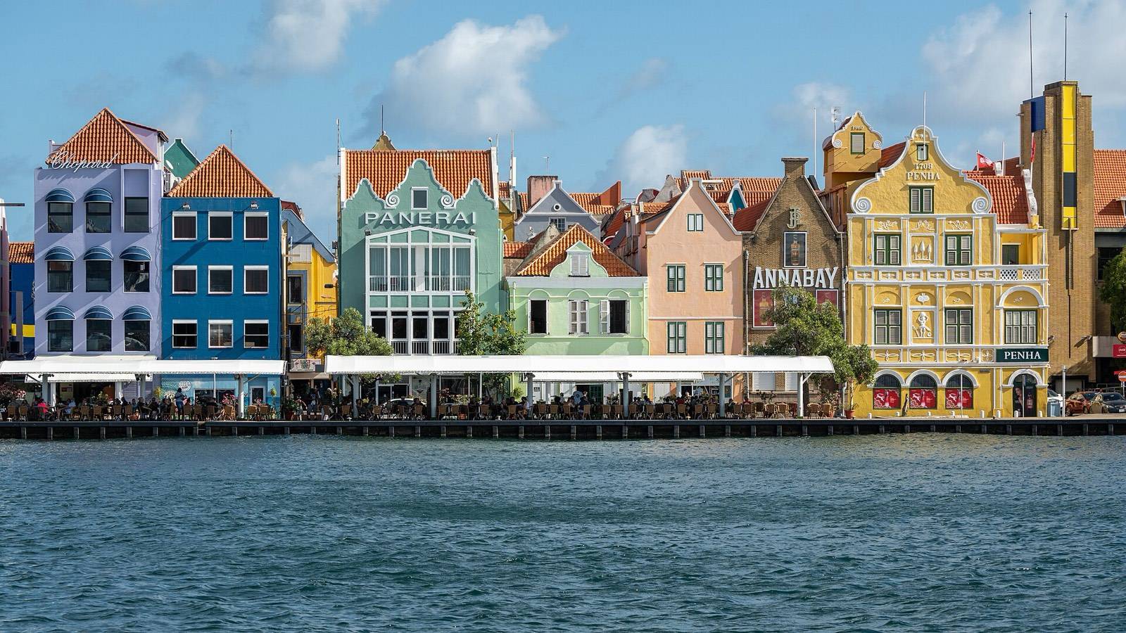The painted facades of the Handelskade seen from the Queen Emma Bridge