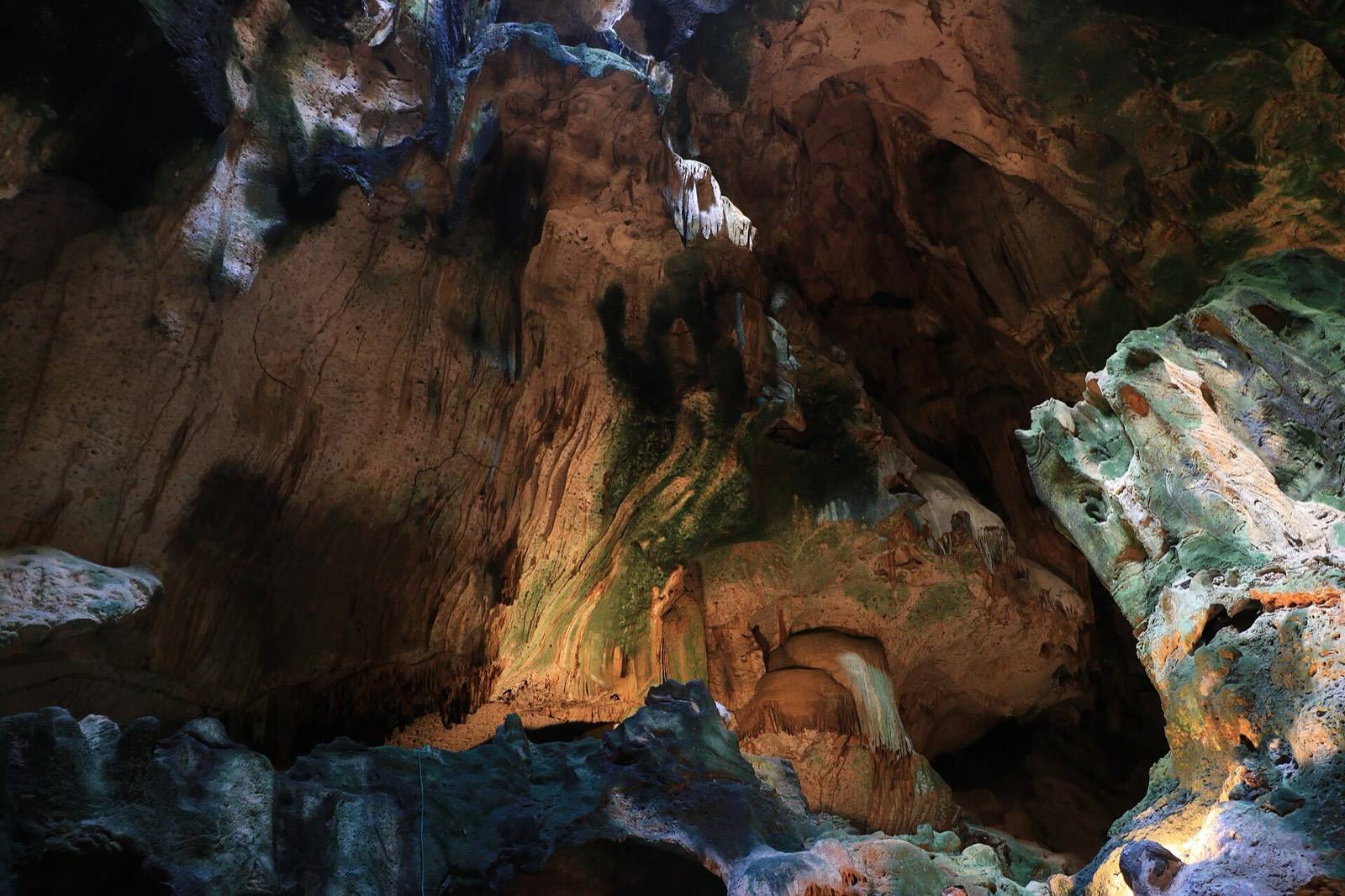 Lit limestone formations inside Hato Caves in Curaçao