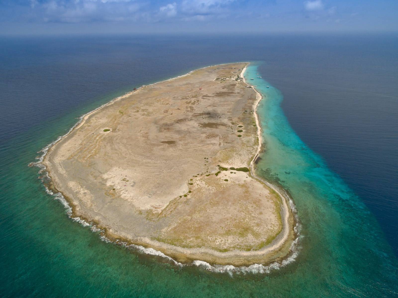 Aerial view of Klein Curaçao, a flat uninhabited islet ringed by white sand and turquoise sea