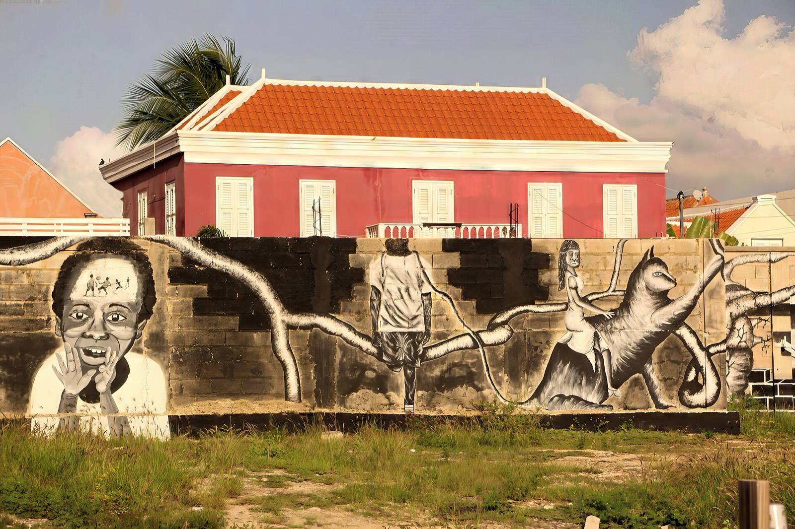 A large, vividly colored mural brightening a wall in Willemstad, Curaçao