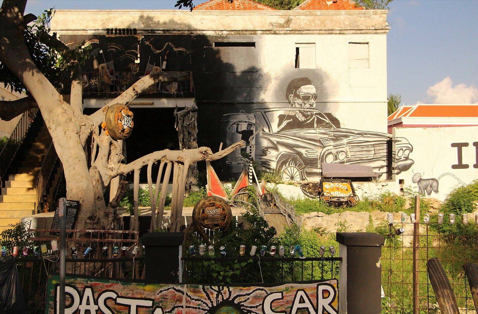 A large colorful mural covering the wall of a historic building in Willemstad, Curaçao